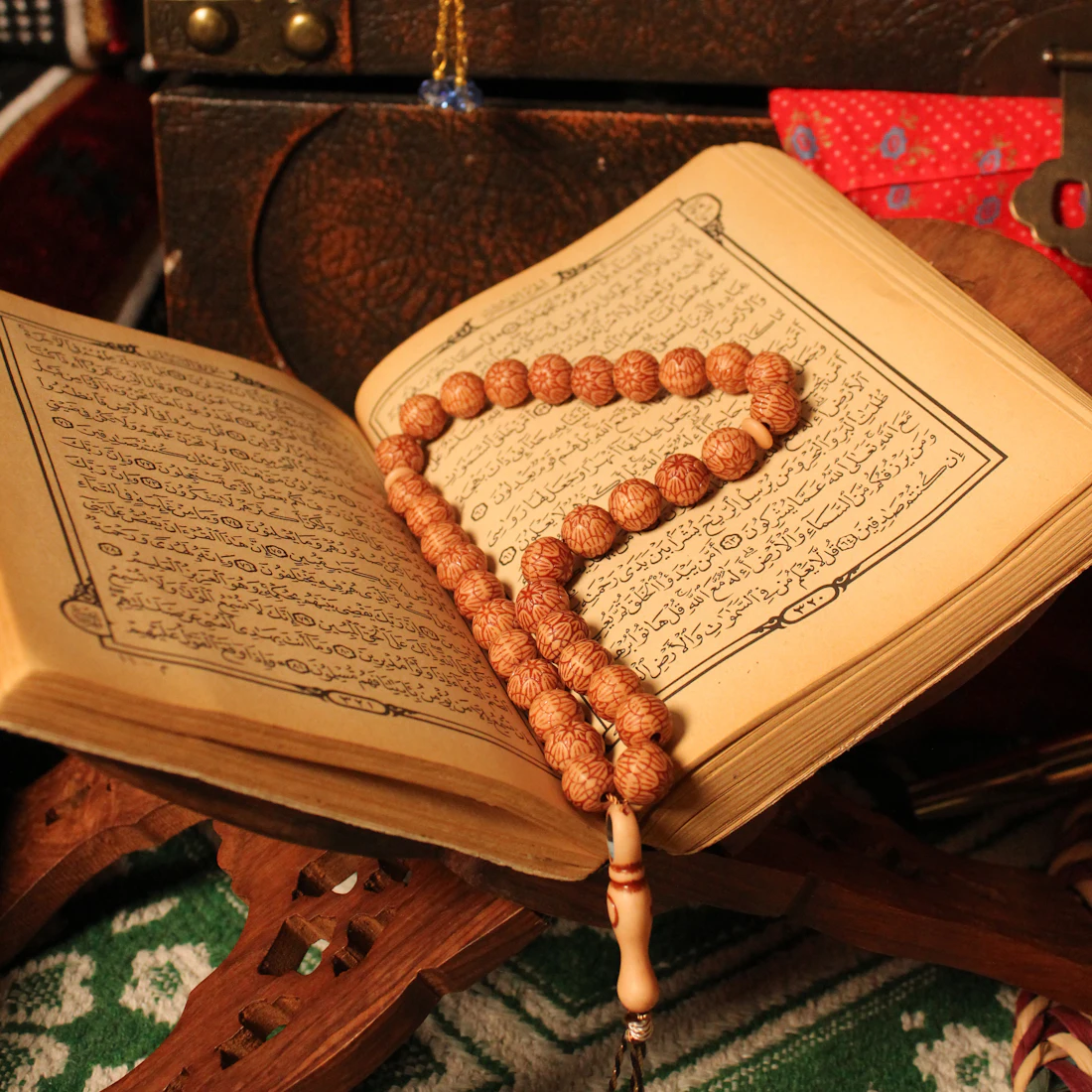 Open Quran with prayer beads resting on the page